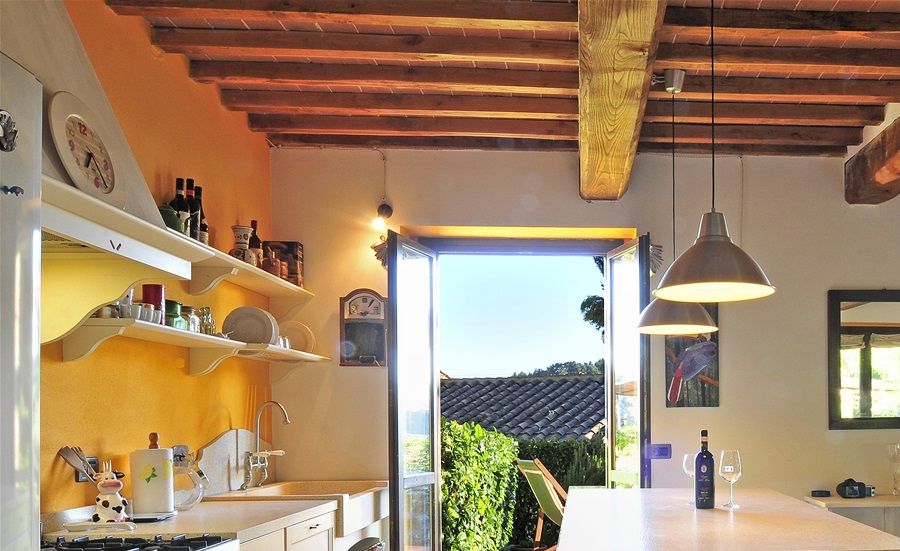 Open space kitchen and dining room with access to the terrace with view.